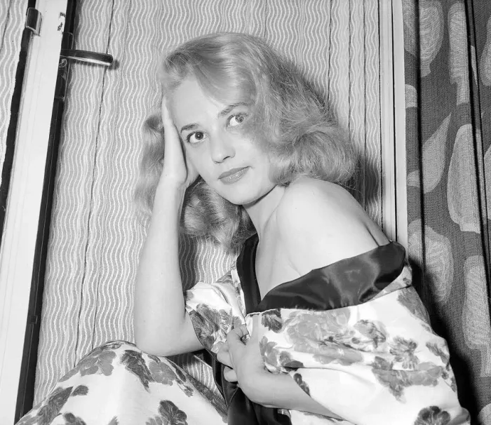 Framed Print : Actress Jeanne Moreau having her picture taken on a hotel bed July 1956