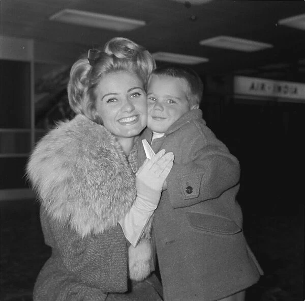 Actress Jill Ireland poses with her young son Paul aged 4 after arriving at London