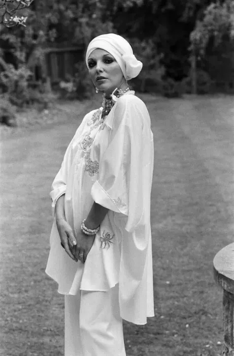 Framed Print : Actress Joan Collins modelling outfits that she will wear on a trip to Tokyo to judge a