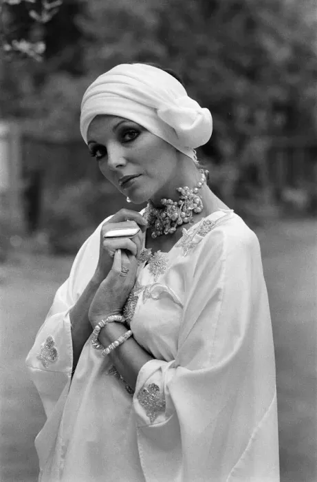 Framed Print : Actress Joan Collins modelling outfits that she will wear on a trip to Tokyo to judge a