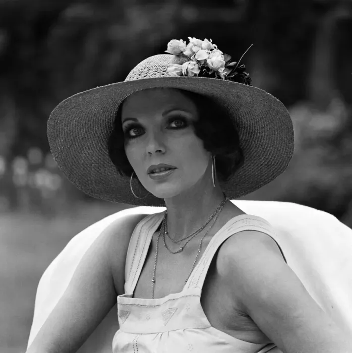 Framed Print : Actress Joan Collins modelling outfits that she will wear on a trip to Tokyo to judge a