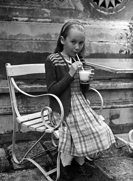 Actress Juliet Mills drinking milk at home. 17th August 1951