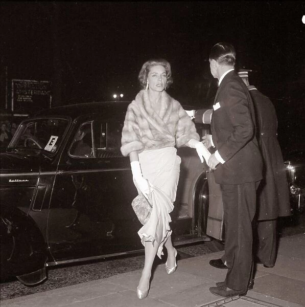 Actress Lauren Bacall is helped out of her car as she arrives at the royal film show The
