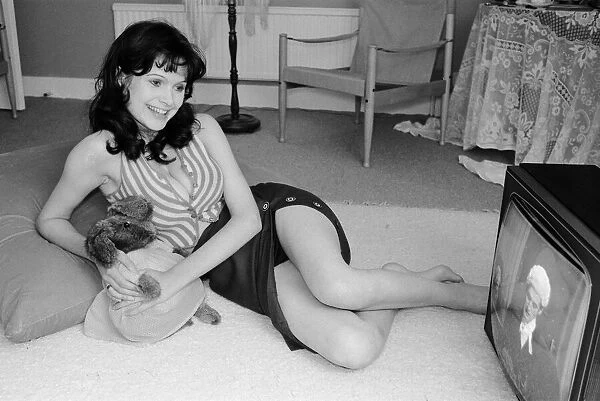 Actress Madeline Smith watching television at her flat in Kew. 6th September 1974