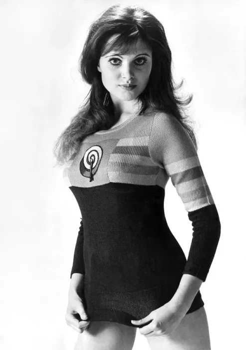 Framed Print : Actress Madeline Smith wears a sweater with an inset from the Allen Jones painting Framed Print : Actress Madeline Smith wears a sweater with an inset from the Allen Jones painting