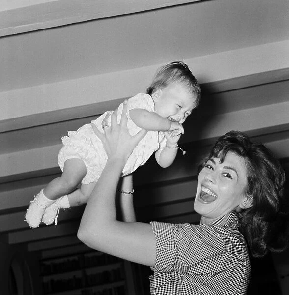 Actress Nanette Newman with her baby daughter Sarah Kate at their home in Virginia Water