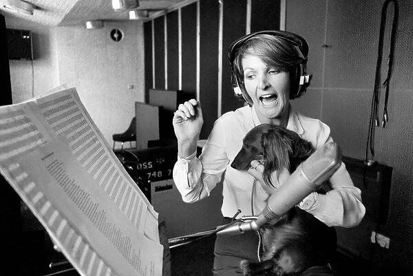 Actress Penelope Keith makes a record about a Dachsund dog. June 1980 80-03067-004