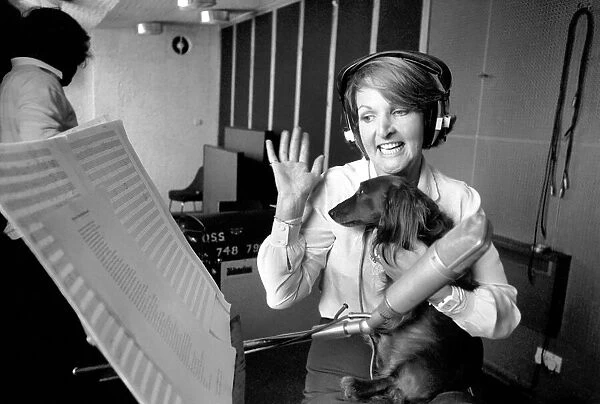 Actress Penelope Keith makes a record about a Dachsund dog. June 1980 80-03067-005