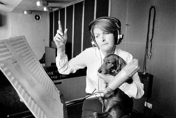 Actress Penelope Keith makes a record about a Dachsund dog. June 1980 80-03067-003