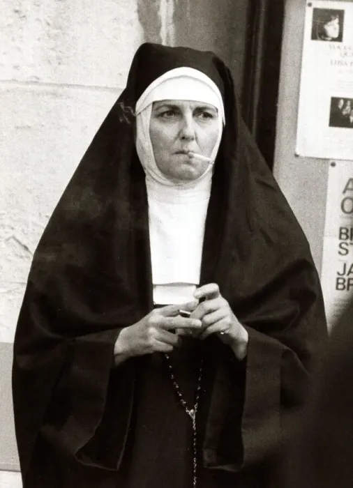 Framed Print : Actress playing the part of a nun takes a cigarette break during filming for A Man Called