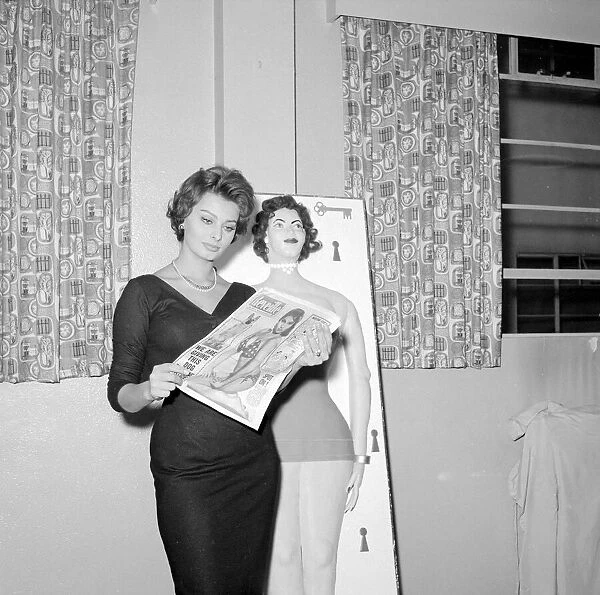 Actress Sophie Loren seen here standing beside a life size cake of her self Circa