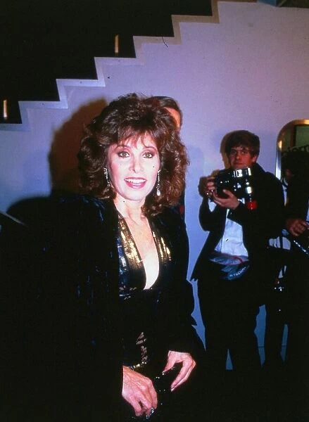 Actress Stephanie Powers February 1989 wearing low cut navy and gold dress