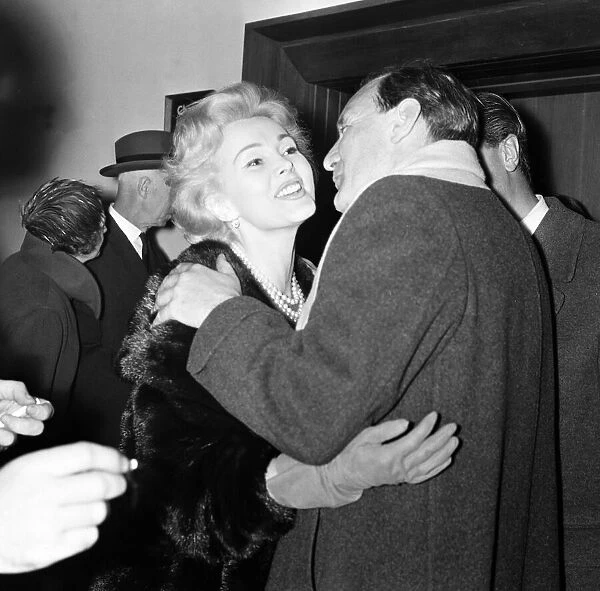 Actress Zsa Zsa Gabor & actor Trevor Howard greet one another on arrival at London