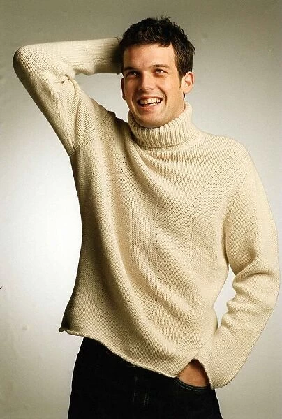 Adam Sinclair Actor January 1999 Studio picture White jumper collar Black trousers