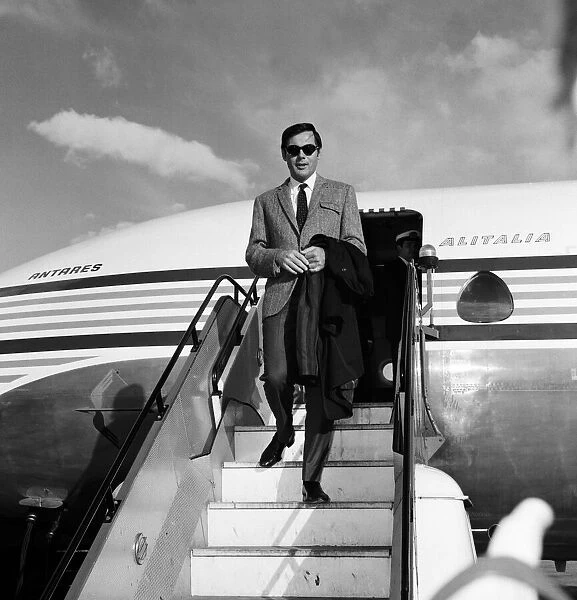 Adam West, who plays Batman on TV, pictured on arrival at Heathrow Airport. 7th May 1967
