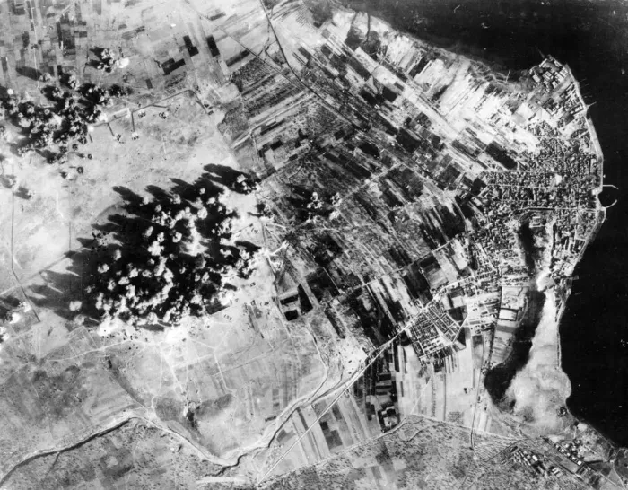 Framed Print : Administration buildings, hangers and revetments are covered by bomb bursts during a Framed Print : Administration buildings, hangers and revetments are covered by bomb bursts during a