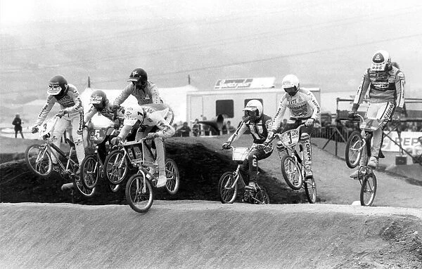 Adults BMX racing over a specially prepared course