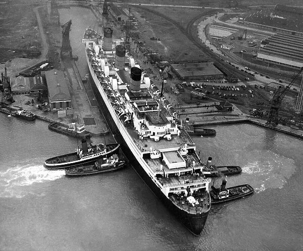 An aerial view of the liner Queen Mary leaving dry dock at Southampton