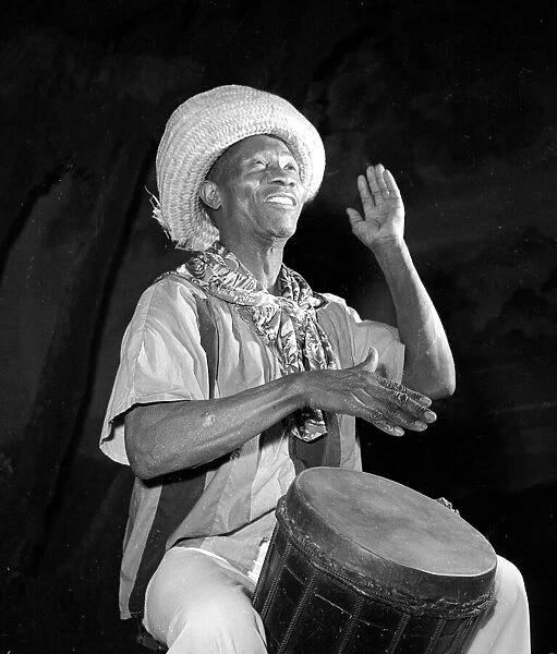 African Drummer Moses playing his instrument November 1951