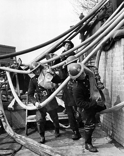 AFS men have to almost fight their way through a maze of pipes. 10th May 1941