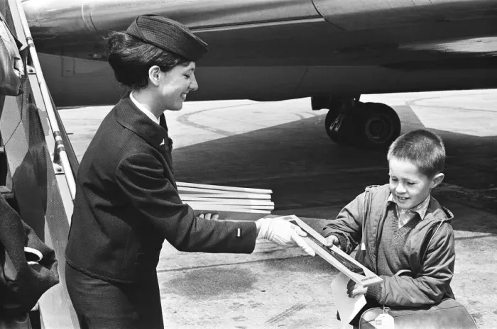 Framed Print : Air hostess with boy at Heathrow airport. 1st June 1965 Framed Print : Air hostess with boy at Heathrow airport. 1st June 1965