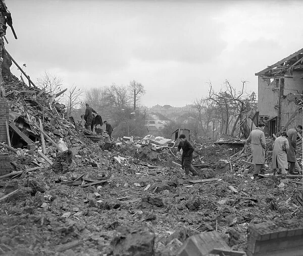 Air Raid Damage in Bristol Civilians searching through rubble of their bomb damaged