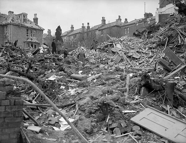 Air raid damage in Coventry Civilians search the rubble of thier bomb damaged