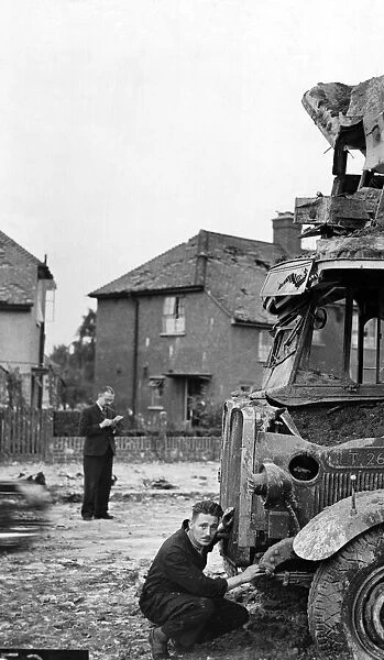 Air Raid damage during the Second World War, a man looking at damage to a bus