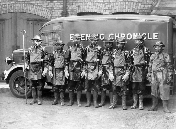 Air raid precautions - Men wearing World War Two gas masks and protective clothing