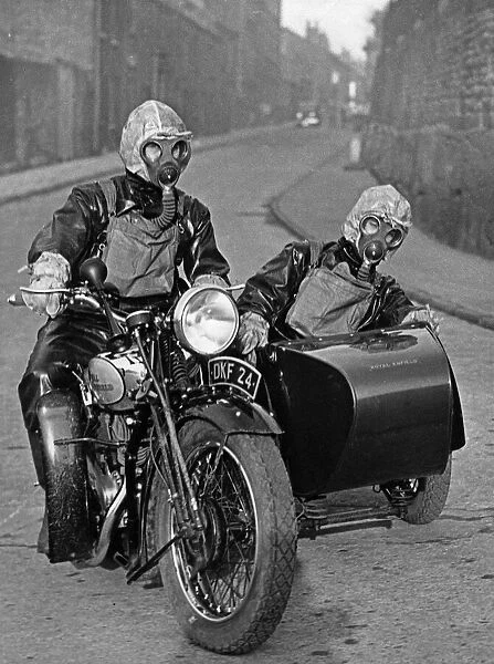 Air raid wardens seen here riding on a motorbike and sidecar during an air raid gas