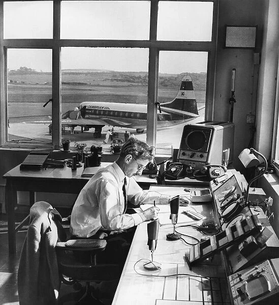 Air traffic controller Mr Gordon Faulkner records the arrival of a viscount aircraft