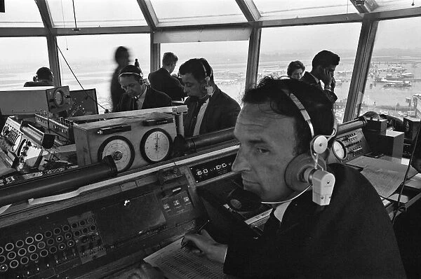 Air traffic controllers in the control tower at Heathrow Airport handling departing