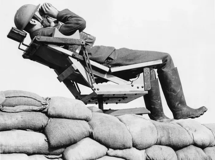 Framed Print : An aircraft observer lies back in a chair on top of a sand bag enforcement scanning Framed Print : An aircraft observer lies back in a chair on top of a sand bag enforcement scanning