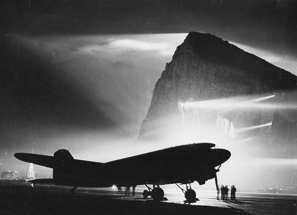 The airfield at Gibraltar is floodlit by night by powerful searchlights from crevices