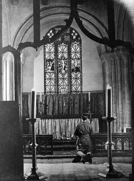Airman of the 8th Army prays at a church in England. December 1943