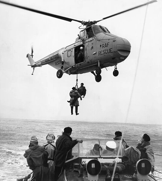 Two airmen are hoisted to the safety of an RAF helicopter after being picked up by Barry