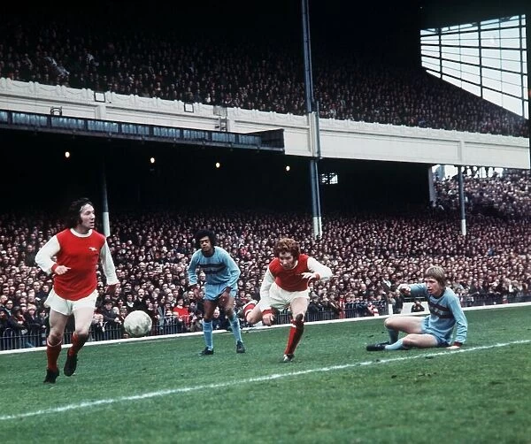 Alan Ball of Arsenal passes the ball to a team mate during their league match against