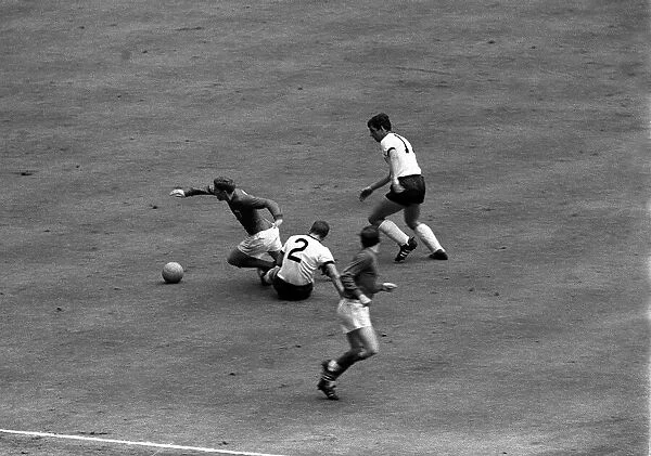 Alan Ball of England goes past West German defenders during the 1966 World Cup