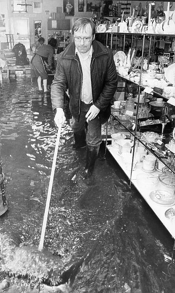 Alan Finney owner of the K Centre shop in Linthorpe seen here helping to bail out water