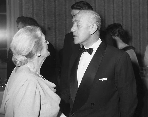 Alec Guinness talking to Sybil Thorndike at the Evening Standard Theatre Awards party