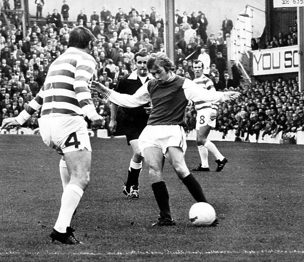 Alex Cropley of Hibernian October 1971 shoots for goal past Bobby Murdoch of