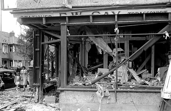 Alfieri. Air Raid damage, Malden. Badly damaged tabacconist. August 16th 1940