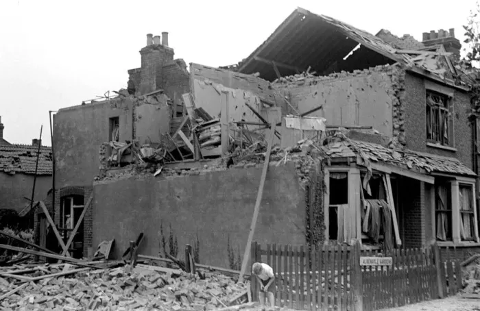 Framed Print : Alfieri. Air raid damage at Malden, London. A young boy sifts through the rubble