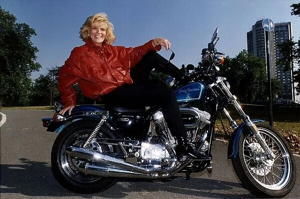 Alison Holloway TV Presenter sitting on her Harley Davidson in Hyde Park