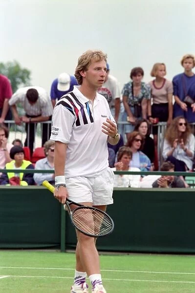 All England Lawn Tennis Championships at Wimbledon. Thoms in action during his