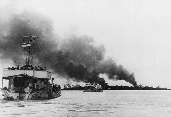 Allied craft travel up the Rangoon River through smoke caused by airstrikes
