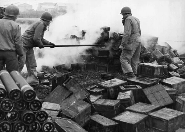 Allied soldiers of the Fifth Army fight to extinguish flames in an ammunition dump in