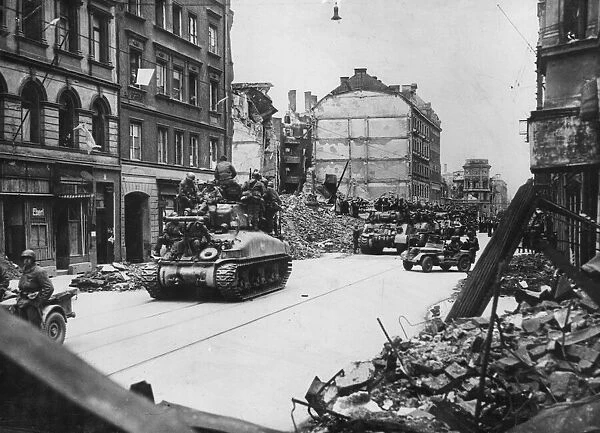 Allied tanks laden with infantry move into a heavily bombed Munich on April 29, 1945
