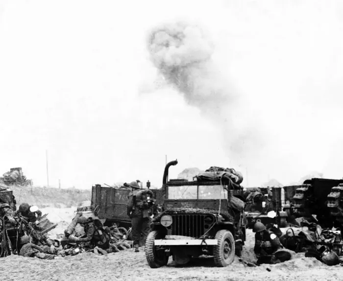 Framed Print : Allied troops take shelter behind their vehicles as German shells pound the French beach