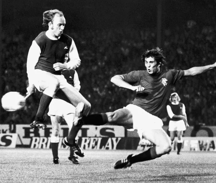 Framed Print : Ally Scott of Hibernian leaps in the air to avoid the legs of Rangers Framed Print : Ally Scott of Hibernian leaps in the air to avoid the legs of Rangers